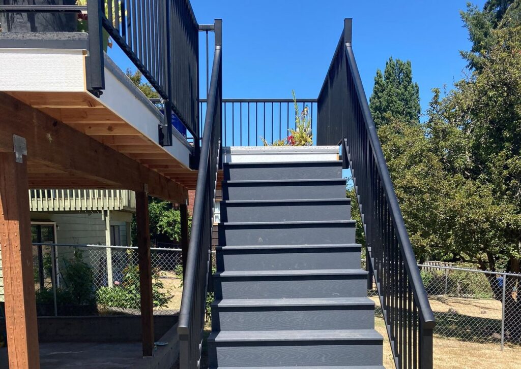 Composite deck stairs with black metal railing by Akraba Construction LLC, serving Allen, TX