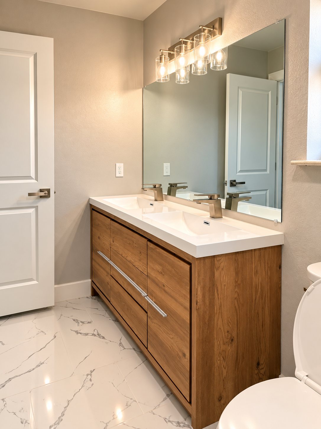 Double wood vanity with black vessel sinks in a bathroom