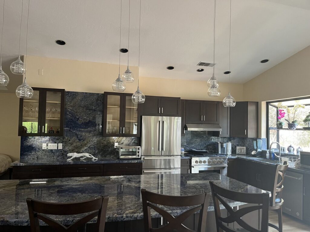 Kitchen remodel with dark wood cabinets, blue granite counters and an island by Akraba Construction LLC, serving Richardson, TX