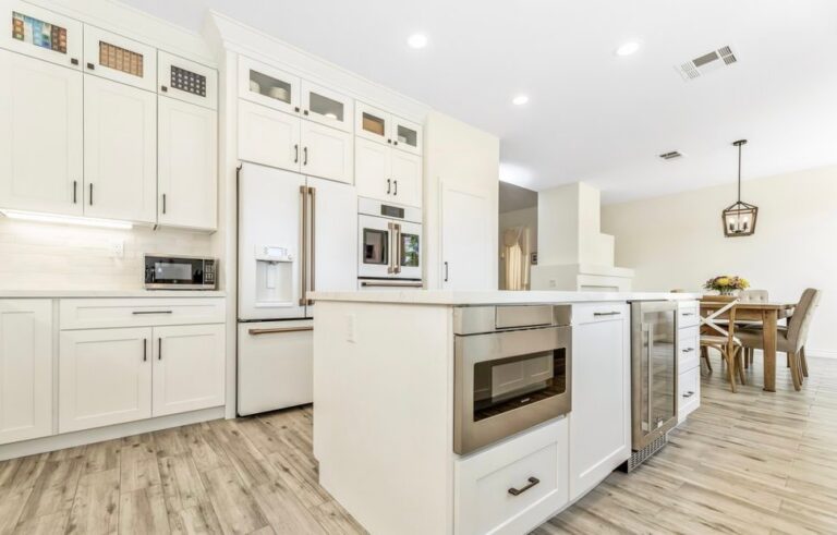White shaker kitchen remodel with a quartz island and white appliances by Akraba Remodeling