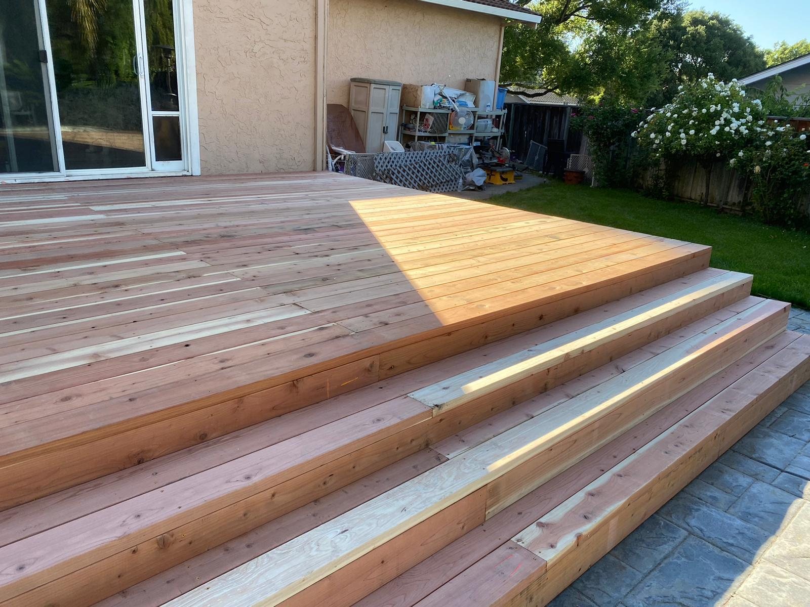 New wood deck with wide wraparound steps built by Akraba Remodeling
