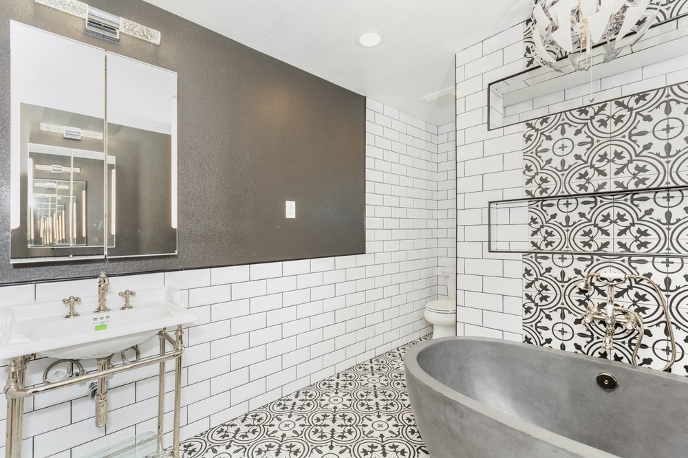 Bathroom remodel with freestanding gray tub and subway tile by Akraba Remodeling